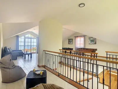 a living room with a couch and a piano at Casa Mes Amis by LovelyStay in Relógio do Poiso