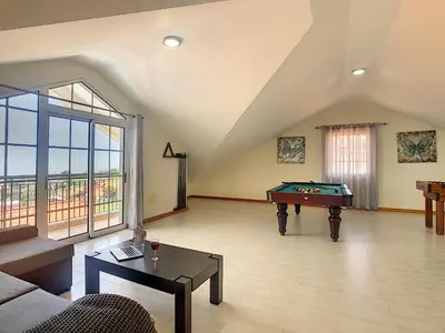 a living room with a couch and a pool table at Casa Mes Amis by LovelyStay in Relógio do Poiso