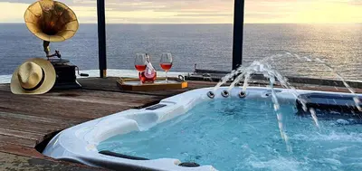 a vase sitting on a white table in front of a mirror at Villa Palace Fernandes with Jacuzzi in Calheta