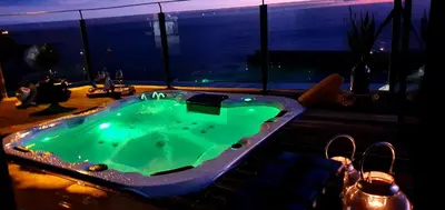a man jumping into a body of water at Villa Palace Fernandes with Jacuzzi in Calheta