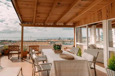 a patio with a table and chairs on a balcony at Atlantic View Penthouse in Funchal