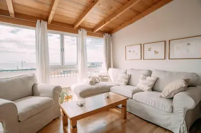 a living room with two couches and a table at Atlantic View Penthouse in Funchal