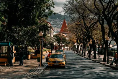 a yellow car parked on the side of a street at Atlantic View Penthouse in Funchal