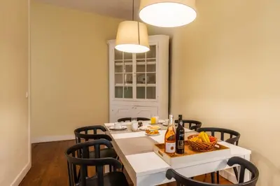 a dining room with a white table and chairs at The Wine Lodges by An Island Apart in Funchal