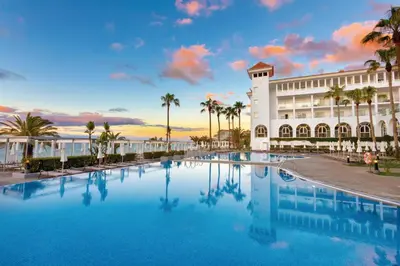 a hotel with a large pool in front of a building at Hotel Riu Madeira - All Inclusive in Caniço