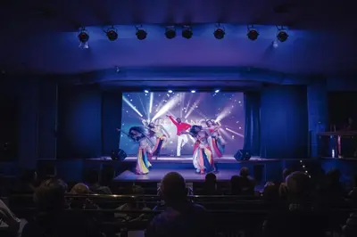 a group of dancers on a stage in a theatre at Hotel Riu Madeira - All Inclusive in Caniço