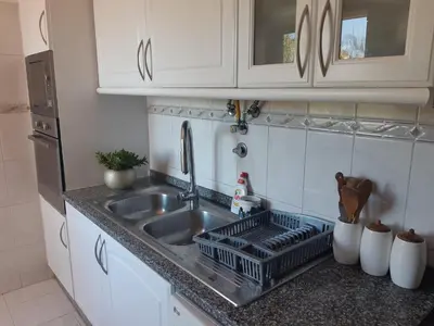 a kitchen sink with a dish rack next to it at Apartamento Marques in Santa Cruz