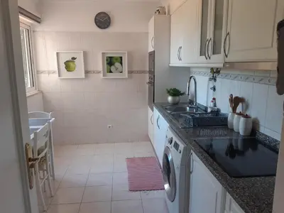 a kitchen with a sink and a washing machine at Apartamento Marques in Santa Cruz