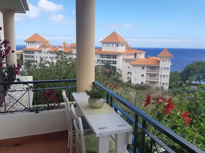 a balcony with a table and chairs and the ocean at Apartamento Marques in Santa Cruz
