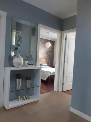 a room with a white shelf with a mirror and a bedroom at Apartamento Marques in Santa Cruz