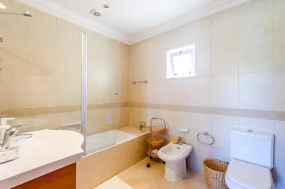 a bathroom with a sink and a toilet and a tub at Casa Mapie - Boavista Resort in Lagos