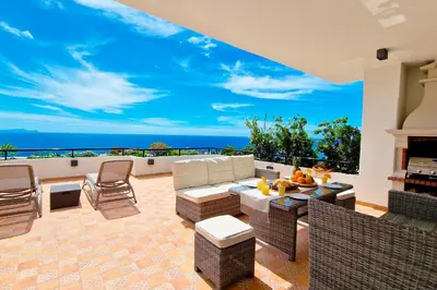 a hot tub on a balcony with a view of the ocean at Casa Ulli by LovelyStay in Caniço