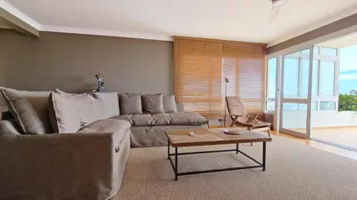 a living room with a couch and a table with a lamp at Casa Ulli by LovelyStay in Caniço