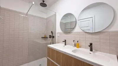 a bedroom with a bed and a door to a bathroom at Casa Ulli by LovelyStay in Caniço