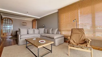 a kitchen with white cabinets and a sink and a microwave at Casa Ulli by LovelyStay in Caniço