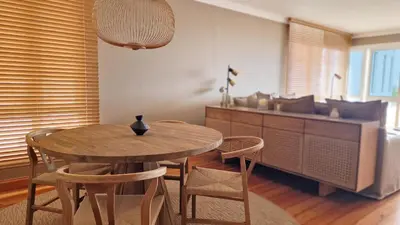 a dining room with a wooden table and chairs at Casa Ulli by LovelyStay in Caniço