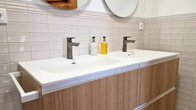 a bathroom with two sinks and a mirror at Casa Ulli by LovelyStay in Caniço