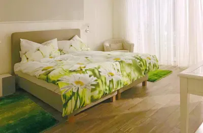 a bedroom with a bed with a flower printed sheets at Holiday Apartment Sunset Ocean in Ribeira Brava