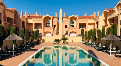 a courtyard with a swimming pool in front of a building at LUXURY APARTMENT - T1 vue sur piscine - PRAIA DA LUZ in Luz