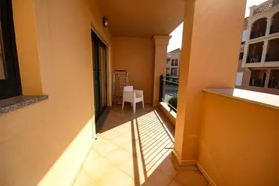 a balcony of a building with a white chair at LUXURY APARTMENT - T1 vue sur piscine - PRAIA DA LUZ in Luz