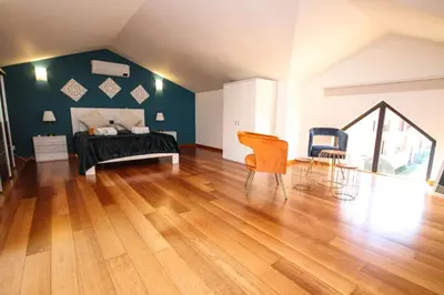 a bedroom with a bed and a wooden floor at LUXURY APARTMENT - T1 vue sur piscine - PRAIA DA LUZ in Luz