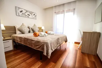 a bedroom with a bed with two pumpkins on it at LUXURY APARTMENT - T2 vue sur piscine - PRAIA DA LUZ in Luz