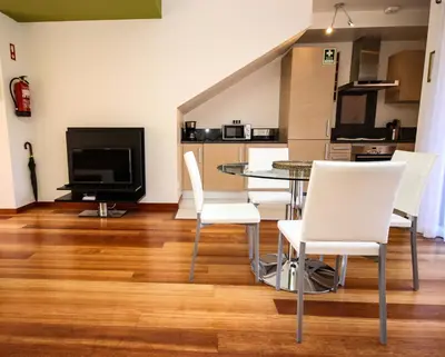 a living room with a table and white chairs at LUXURY APARTMENT - T2 vue sur piscine - PRAIA DA LUZ in Luz