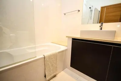 a white bathroom with a sink and a bath tub at LUXURY APARTMENT - T2 vue sur piscine - PRAIA DA LUZ in Luz