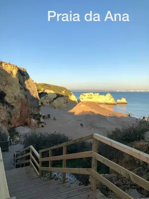 a view of a beach with a wooden boardwalk at LUXURY APARTMENT - T2 vue sur piscine - PRAIA DA LUZ in Luz