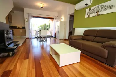 a living room with a couch and a table at LUXURY APARTMENT - T2 vue sur piscine - PRAIA DA LUZ in Luz