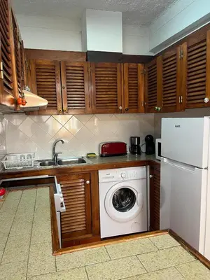 a kitchen with a washing machine and a white refrigerator at Sea Light Seaview Vista Mar Apartment - Luz, Lagos in Luz