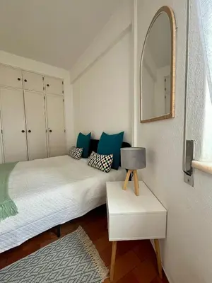 a bedroom with two beds with blue pillows and a mirror at Sea Light Seaview Vista Mar Apartment - Luz, Lagos in Luz