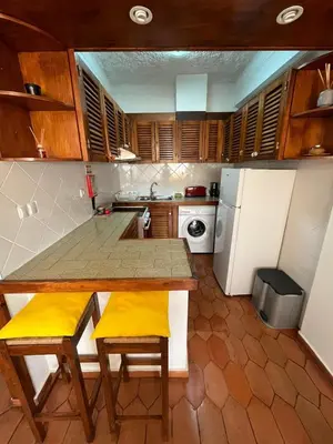 a kitchen with a wooden table and yellow chairs at Sea Light Seaview Vista Mar Apartment - Luz, Lagos in Luz