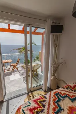 a bedroom with a view of the ocean at maktub sunset property in Paul do Mar