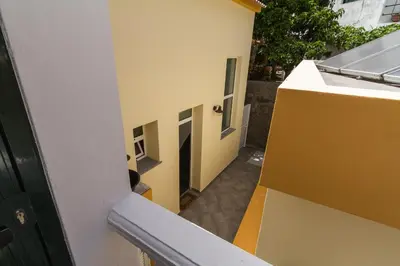 an empty hallway of a building with a door open at maktub sunset property in Paul do Mar
