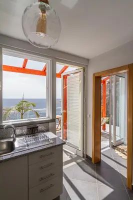 a kitchen with a view of the ocean at maktub sunset property in Paul do Mar