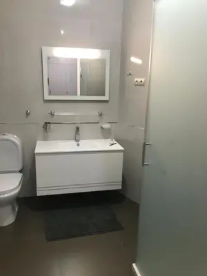 a bathroom with a sink and a toilet and a mirror at Ammy’s House in Câmara de Lobos
