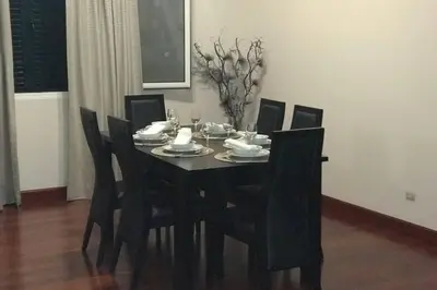 a dining room table with black chairs and a black table and chairsktop at Ammy’s House in Câmara de Lobos
