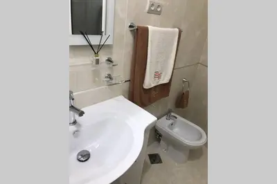 a bathroom with a white sink and a toilet at Ammy’s House in Câmara de Lobos