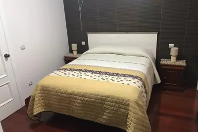 a bedroom with a large bed with two night stands at Ammy’s House in Câmara de Lobos