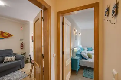 a living room with a couch and a bed at Refúgio Na Praia Da Luz in Luz