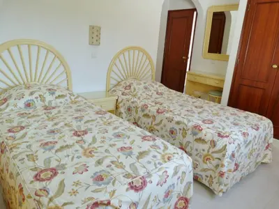 a bedroom with two beds and a mirror at Casa Rosa Floresta in Luz