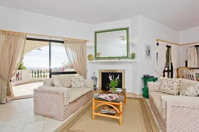 a living room with two couches and a fireplace at Casa dos Cardos in Luz