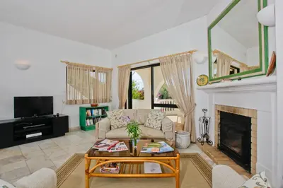 a living room with a couch and a fireplace at Casa dos Cardos in Luz