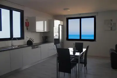 a kitchen and dining room with a table and chairs at GuestReady - Sonho dos Avós in Câmara de Lobos