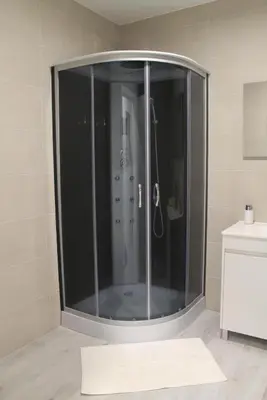 a shower with a glass door in a bathroom at GuestReady - Sonho dos Avós in Câmara de Lobos