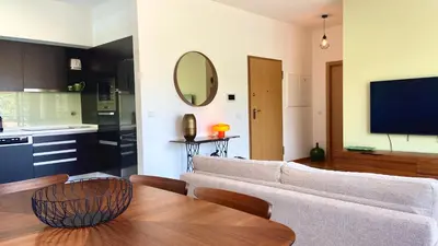 a living room with a couch and a table at Madeira Mero Apartment in Caniço