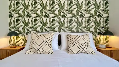 a white bed with two pillows in a bedroom at Madeira Mero Apartment in Caniço