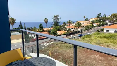 a balcony with a view of the ocean at Madeira Mero Apartment in Caniço
