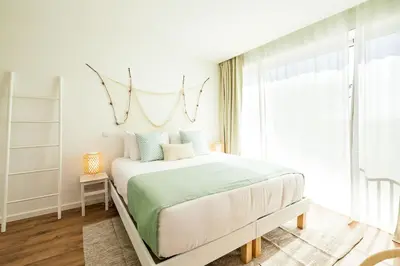 a bedroom with a bed and a window at Casa Vica - Sagres Apartments in Sagres